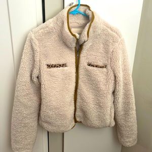 Zip up teddy coat with animal print pocket lining. Medium